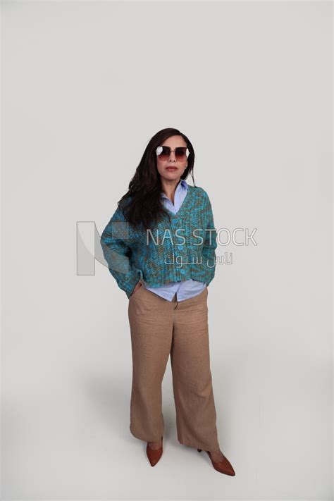 Woman Putting Her Hand In Her Pocket And Wearing Sunglasses