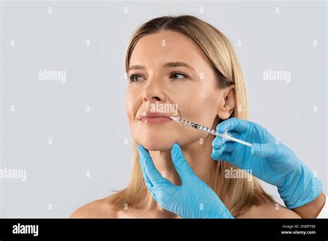 Middle Aged Woman Gets Cosmetic Injection In Her Lips Clpseup Stock