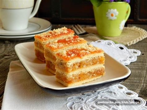 Three Pieces Of Cake On A White Plate Next To A Cup And Saucer With