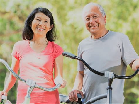 Elderly Asian Couple With Bikes