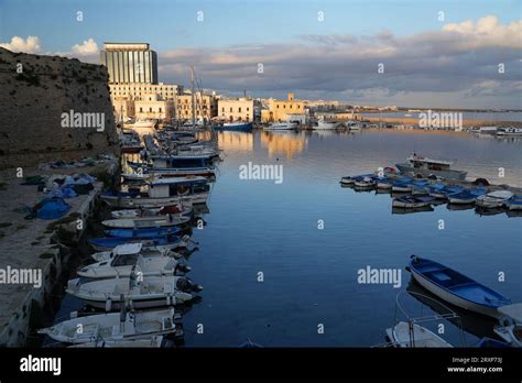 Boats moored in harbour next to old city wall in Gallipoli old town ...