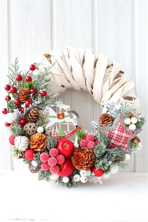 A Christmas Wreath With Pine Cones Berries And Other Holiday