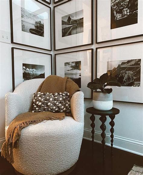 A White Chair Sitting In Front Of A Wall With Pictures On It S Walls