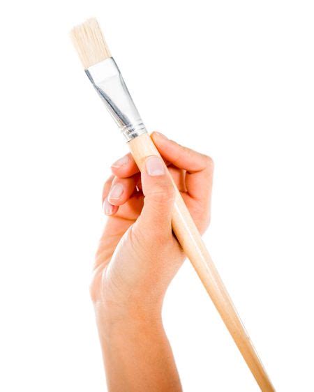 Hand Holding A Paint Brush Isolated Over A White Background