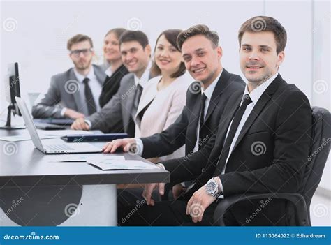 Project Manager And Professional Business Team Sitting At Desk Stock