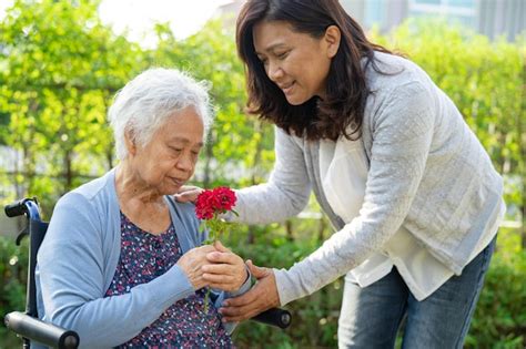 Premium Photo Caregiver Daughter Hug And Help Asian Senior Or Elderly