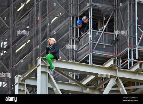 Police Watch An Extinction Rebellion Protester Who Has Scaled The