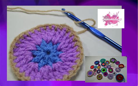 A Crocheted Bag With Buttons And A Knitting Needle