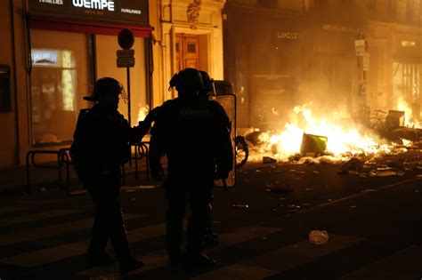 IN PHOTOS: Fiery protests erupt across France after Macron pushes ...