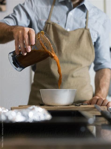 Man Pouring Soup To Bowl By Stocksy Contributor Milles Studio