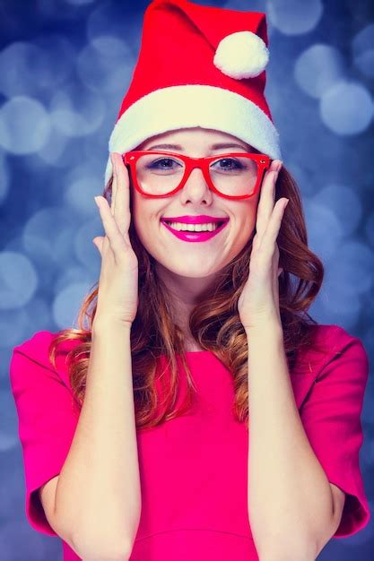 Premium Photo Redhead Girl In Christmas Hat And Glasses On Gray