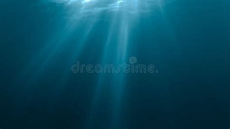 Sunlight Rays Shining Through Ocean Surface View From Underwater Stock