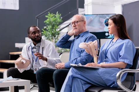 Premium Photo Diverse Medical Team Helping Injured Patient To Take