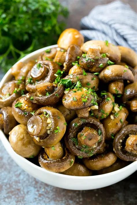 A Bowl Of Roasted Mushrooms Coated In A Garlic And Herb Butter And