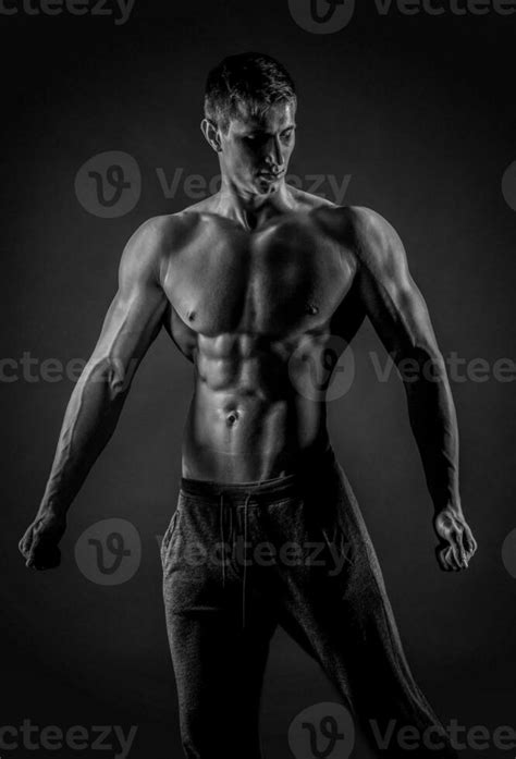 Sexy Muscular Man Posing With Naked Torso On Black Background Stock Photo At Vecteezy
