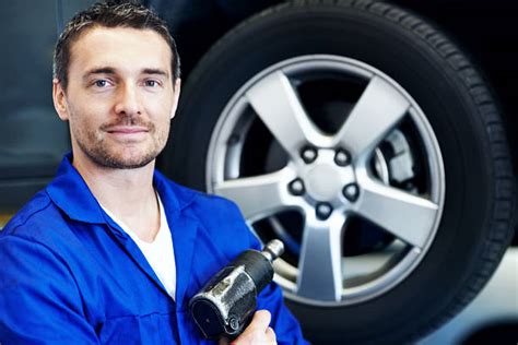 40 Smiling Mechanic With Arms Crossed Standing By Tire Stock Photos