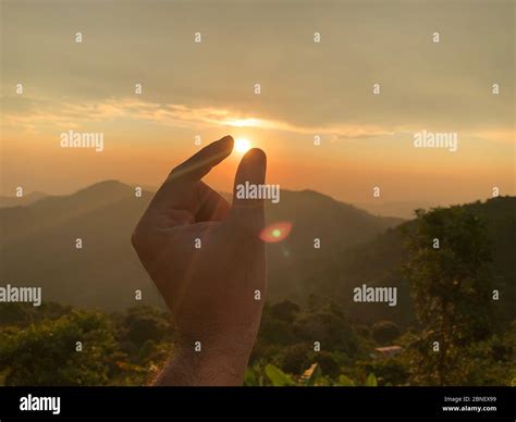 Catching The Sun With One Hand Stock Photo Alamy