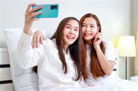 Happy Asian Lesbian Couple Using Smartphones Taking Pictures Together Stock Photo Image Of
