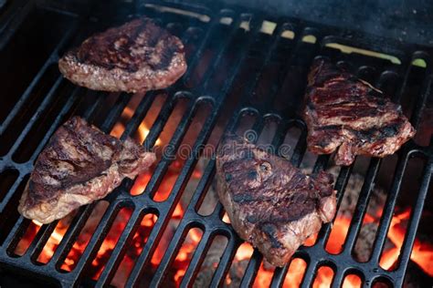 Four Beef Steaks Being Grilled Over Hot Coals Stock Image Image Of