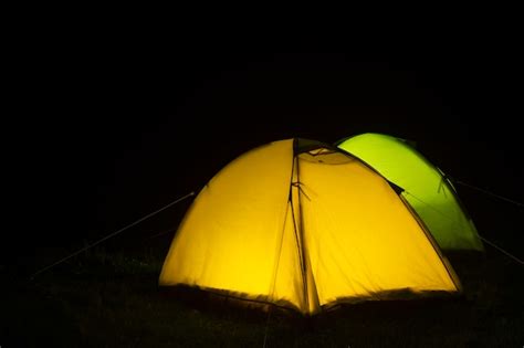 Premium Photo | Camping tents at night in nature glow inside.