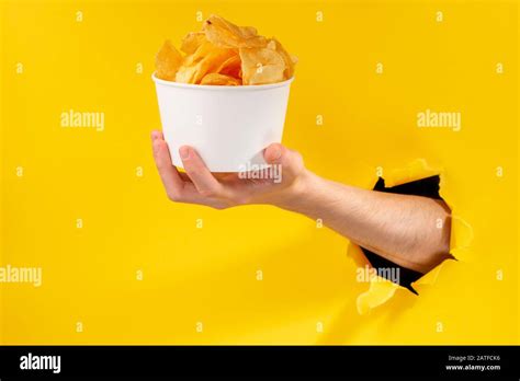 Hand Giving A Cup Of Potato Chips Stock Photo Alamy