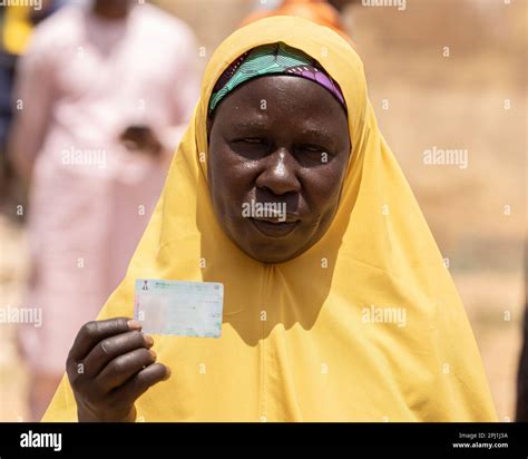 A Woman Displays Her Voters Card During The Gubernatorial Election In