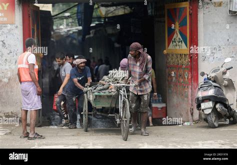 A Worker Carries Debris After Clearing The Market As Floodwaters Of The