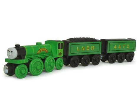 a green and black toy train on white background