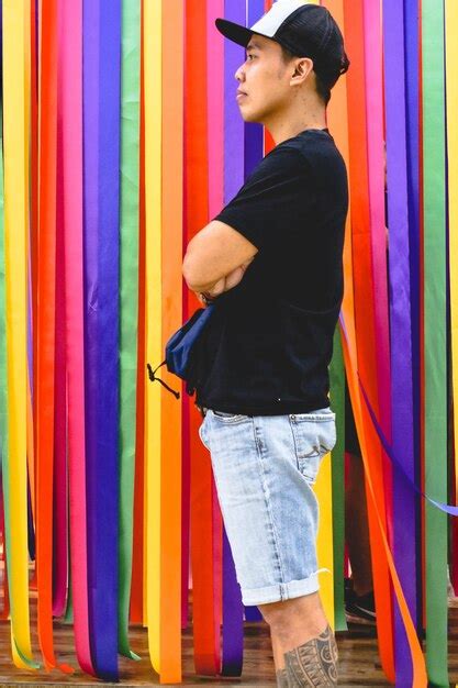 Premium Photo Side View Of Man Wearing Cap While Standing By Colorful