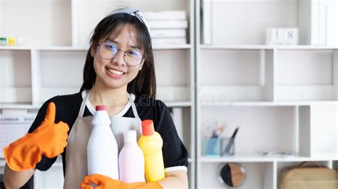 Beautiful Asian Housewife Wearing Apron And Cleaning Gloves Prepares To Clean Her House Stock