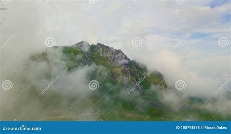 Drone Aerial View Flying Above the Clouds Towards a Beautiful Green Mountain Scenary Stock Image ...