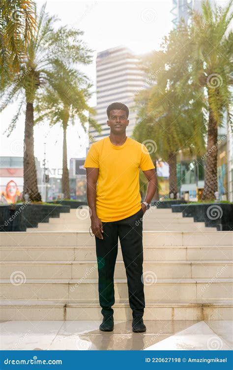 Full Length Portrait Of Handsome Black African Man Wearing Yellow T