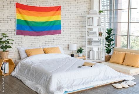 Large Rainbow Colorful Gay Pride Flag Hanging On Brick Wall Pattern