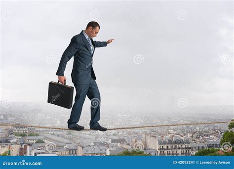 Businessman Walking Tightrope Above City Stock Photo - Image: 42093241