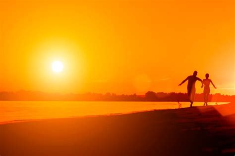 Premium Photo Naked Man And A Woman Running On The Beach At Sunset