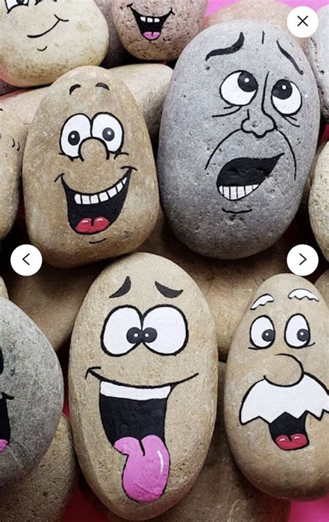 Some Rocks With Faces Painted On Them Are Arranged In A Circle And Have