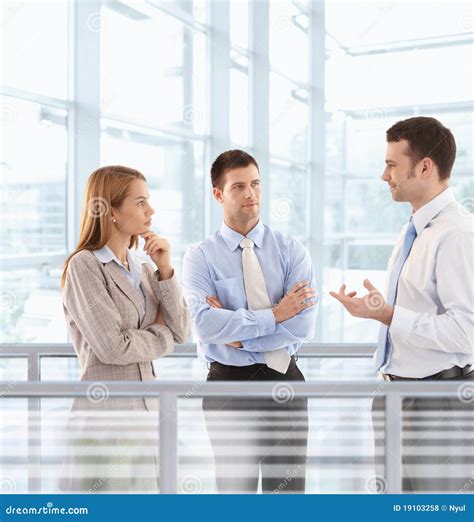 Businesspeople Chatting In Modern Office Lobby Stock Photo Image