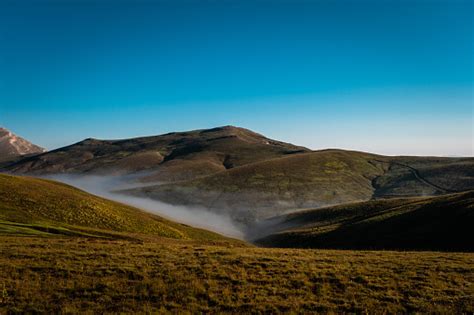 Green Meadows Foggy Lowlands Mountain Range Landscape Stock Photo