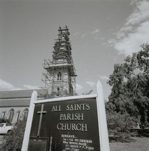 All Saints Parish Church sign of church with tower is in the background ...