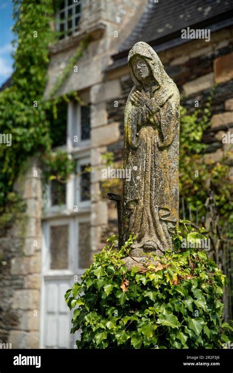 Stone Statue Of A Praying Woman In Robe In The Castle Park Rochefort