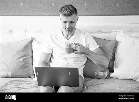 Busy Mature Man Using Computer In Bed With Coffee Stock Photo Alamy