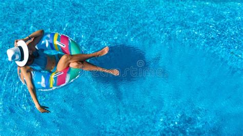 Portrait Of Beautiful Tanned Woman Relaxing In Bikini And Hat In Swimming Pool Gel Polish Red