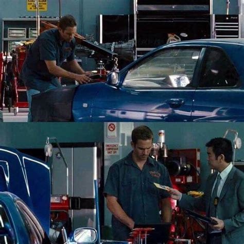 Two Men Working On Cars In A Garage