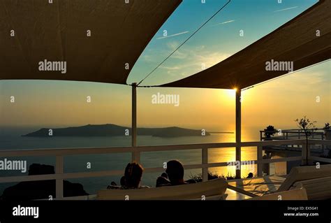 A sunset view from a hotel balcony in Santorini Greece Stock Photo - Alamy