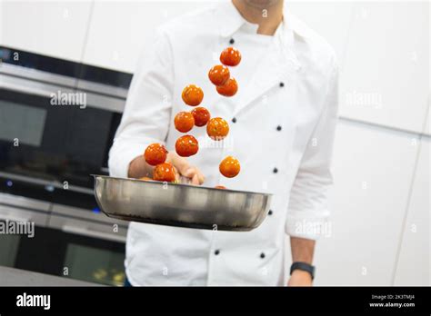 Crop Man In White Chef Jacket With Frying Pan With Cherry Tomatoes With