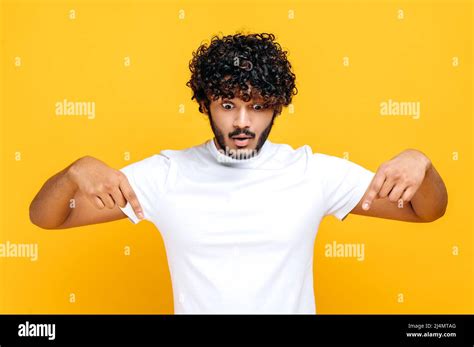 Surprised Indian Or Arabian Shocked Curly Haired Guy In Basic White T