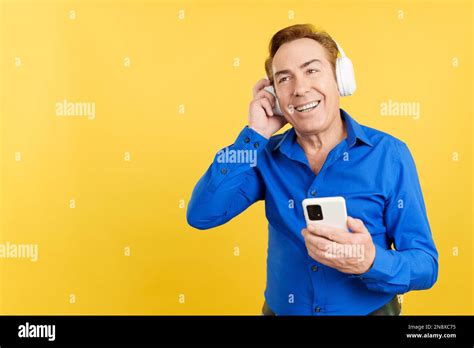 Smiley Mature Man Listening To Music With The Mobile Stock Photo Alamy