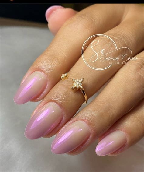 A Woman S Hand With Pink Manies And A Gold Ring On Her Finger