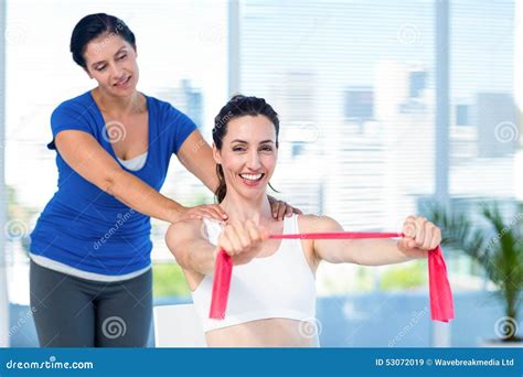 Brunette Stretching With Her Coach And Pink Cloth Stock Image Image