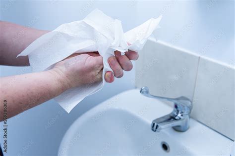 Handwashing Drying Hands With Paper Towel After Washing At Basin